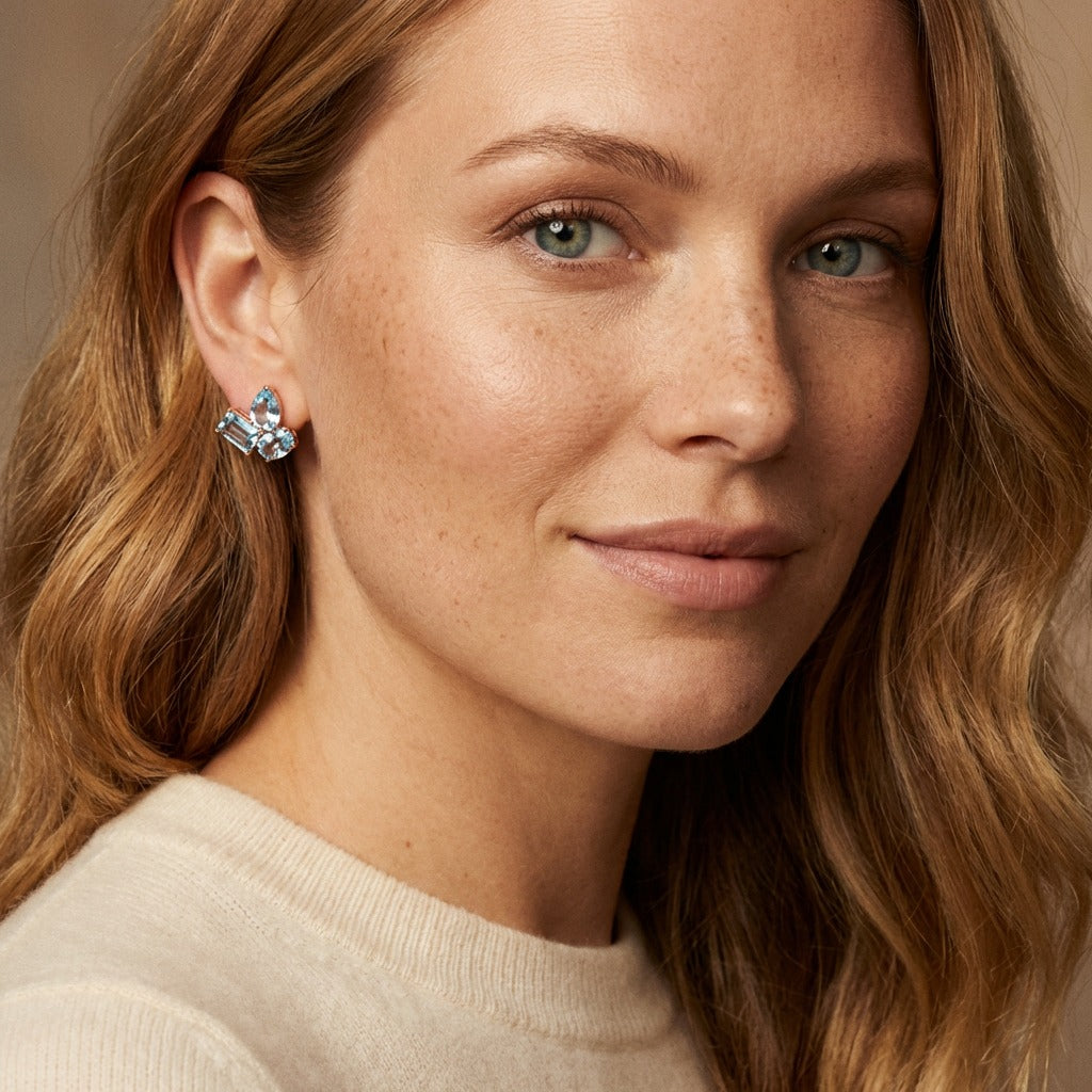 Rose gold gemstone stud earrings with blue topaz